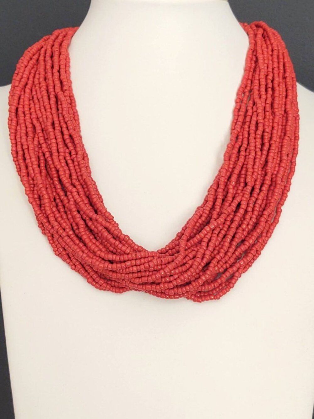 Layered orange beaded necklace with old coin toggle closure